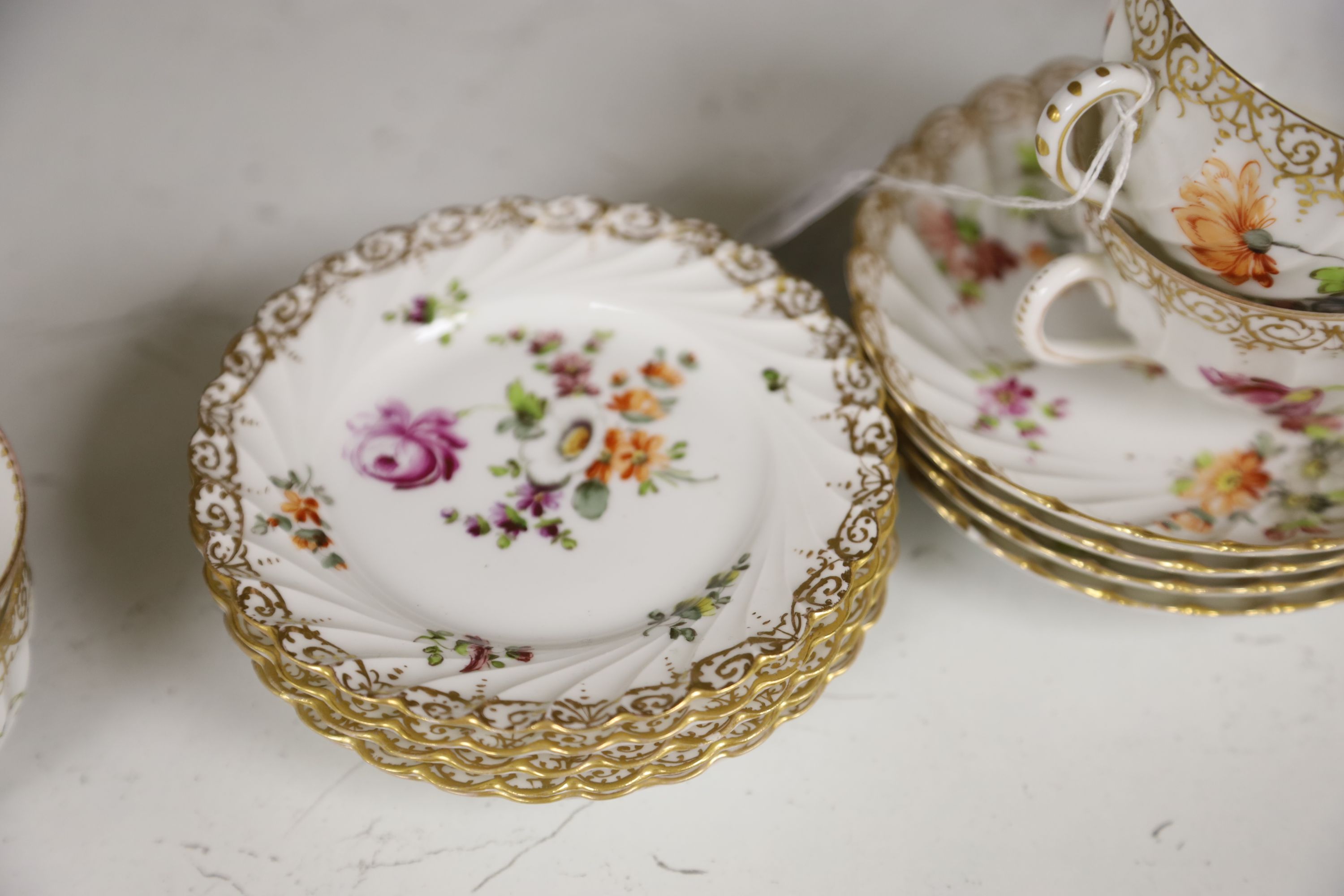 A Dresden-style pierced oval flower-encrusted bowl with branch feet and handles and a Dresden part tea service (15-pce)